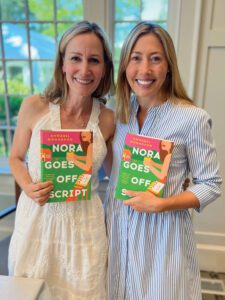 A photo of Annabel Monaghan holding her book, "Nora Goes Off Script"
